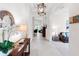 Inviting foyer with neutral walls and flooring, decorative mirror, and chandelier at 1034 Buttercup Gln, Bradenton, FL 34212