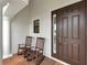 Cozy front porch with two rocking chairs and a decorative front door at 1034 Buttercup Gln, Bradenton, FL 34212