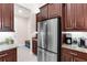 Kitchen features stainless steel refrigerator, granite countertops, and ample cabinet space at 1034 Buttercup Gln, Bradenton, FL 34212