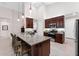 Modern kitchen with stainless steel appliances, granite countertops, and a large island at 1034 Buttercup Gln, Bradenton, FL 34212