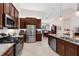 Spacious kitchen with granite counters, stainless steel appliances, and seamless flow to the dining area at 1034 Buttercup Gln, Bradenton, FL 34212
