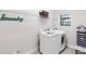 Bright laundry room features modern washer and dryer and shelving for storage at 1034 Buttercup Gln, Bradenton, FL 34212
