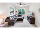 Cozy living room features a sectional sofa, ceiling fan, and access to the outdoors at 1034 Buttercup Gln, Bradenton, FL 34212