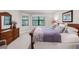 Main bedroom featuring a wood bed frame, dresser, and large windows at 1034 Buttercup Gln, Bradenton, FL 34212
