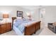 Main bedroom featuring a wood bed frame, end tables, and an accent chair at 1034 Buttercup Gln, Bradenton, FL 34212