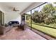 Screened-in patio with brick floor and ceiling fan provides outdoor living space at 1034 Buttercup Gln, Bradenton, FL 34212