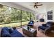 Screened-in patio with brick floor and ceiling fan offers serene backyard views at 1034 Buttercup Gln, Bradenton, FL 34212