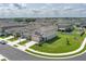 Two-story home with beige siding, a two-car garage, surrounded by a well-manicured lawn at 10464 Ladybug Cv, Parrish, FL 34219