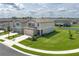 Aerial view of a home with a green lawn in a neighborhood with similar-style houses at 10464 Ladybug Cv, Parrish, FL 34219