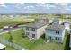 Aerial view of the backyards, highlighting the green lawns, patios, and landscaping at 10464 Ladybug Cv, Parrish, FL 34219