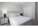 Cozy bedroom featuring a queen-size bed, stylish nightstands, and neutral decor at 10464 Ladybug Cv, Parrish, FL 34219