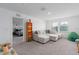 Bonus room with a cozy sectional sofa, bright windows, and views of the neighborhood at 10464 Ladybug Cv, Parrish, FL 34219