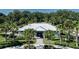 A view of the Summerwoods clubhouse with palm trees and lush landscaping at 10464 Ladybug Cv, Parrish, FL 34219