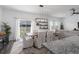 Bright dining room with white accents and a sliding glass door that leads to the backyard at 10464 Ladybug Cv, Parrish, FL 34219