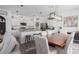 Open concept kitchen and dining area with stainless steel appliances and white cabinetry at 10464 Ladybug Cv, Parrish, FL 34219