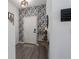 Inviting entryway with stylish wallpaper, modern light fixture, and elegant decor at 10464 Ladybug Cv, Parrish, FL 34219