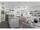 Open-concept kitchen and living area with a granite island, stainless steel appliances, and modern lighting at 10464 Ladybug Cv, Parrish, FL 34219