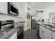 Well-equipped kitchen with stainless steel appliances, granite countertops, and a breakfast bar at 10464 Ladybug Cv, Parrish, FL 34219