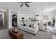 Spacious living room flowing into kitchen and dining area, featuring stylish decor and furnishings at 10464 Ladybug Cv, Parrish, FL 34219