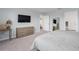 Spacious main bedroom with a mounted television and ensuite bathroom access at 10464 Ladybug Cv, Parrish, FL 34219