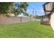 Spacious backyard with lush green grass and a tall fence offering privacy at 1052 Concord W Dr, Dunedin, FL 34698