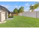 Large grassy backyard with full fence offering privacy at 1052 Concord W Dr, Dunedin, FL 34698