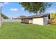 Backyard showing lush green grass and partial fencing, enhancing privacy at 1052 Concord W Dr, Dunedin, FL 34698