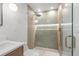 Elegant shower with tiled walls, rain shower head, and frameless glass door at 1052 Concord W Dr, Dunedin, FL 34698