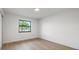 Bright bedroom with a large window offering outdoor views and beautiful flooring at 1052 Concord W Dr, Dunedin, FL 34698