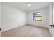 Bright bedroom featuring a large window, natural light, and light wood flooring at 1052 Concord W Dr, Dunedin, FL 34698