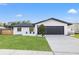 Charming single-Gathering home featuring a well-maintained lawn and sleek, modern design elements at 1052 Concord W Dr, Dunedin, FL 34698