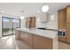 Bright kitchen featuring an island, modern lighting, and stainless steel appliances at 1052 Concord W Dr, Dunedin, FL 34698