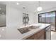 Close-up of a kitchen island featuring quartz countertops and a stainless steel sink at 1052 Concord W Dr, Dunedin, FL 34698