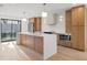 Modern kitchen with sleek cabinets, an island with quartz countertops, and stainless steel appliances at 1052 Concord W Dr, Dunedin, FL 34698