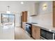 Stylish kitchen with stainless steel appliances, modern countertops, and a view to the back yard at 1052 Concord W Dr, Dunedin, FL 34698