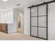 Close up of the ensuite bathroom, wet bar and glass sliding door of the main bedroom at 1052 Concord W Dr, Dunedin, FL 34698