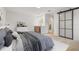 Serene main bedroom with modern furniture, wet bar and sliding glass door to the ensuite bathroom at 1052 Concord W Dr, Dunedin, FL 34698