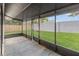 Enclosed patio with screens offering an outdoor living space overlooking the backyard at 1052 Concord W Dr, Dunedin, FL 34698