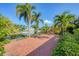 Spacious brick patio area overlooking peaceful canal and palm trees, great for outdoor living at 1104 76Th Nw St, Bradenton, FL 34209
