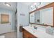 Fresh bathroom featuring a wood vanity, framed mirror, and modern lighting at 1104 76Th Nw St, Bradenton, FL 34209