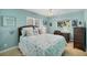 Bright bedroom with a patterned bedspread, decorative pillows, and a ceiling fan at 1104 76Th Nw St, Bradenton, FL 34209