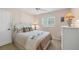 Welcoming bedroom featuring soft lighting, a decorative bedspread, and ample closet space at 1104 76Th Nw St, Bradenton, FL 34209