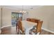 Bright dining room featuring wood floors, stylish lighting, and sliding doors to outdoor space at 1104 76Th Nw St, Bradenton, FL 34209