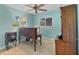 Bright home office with an adjustable desk, a cushioned chair, and two windows for natural light at 1104 76Th Nw St, Bradenton, FL 34209