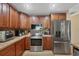 This spacious kitchen is equipped with stainless steel appliances, wood cabinetry, and tile countertops at 1104 76Th Nw St, Bradenton, FL 34209