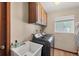 Bright laundry room with ample cabinets, sink, and modern washer and dryer at 1104 76Th Nw St, Bradenton, FL 34209
