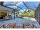 Screened-in pool area with lounge chairs and outdoor seating, perfect for entertaining at 1104 76Th Nw St, Bradenton, FL 34209