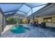 Sparkling pool with screened enclosure, outdoor seating, and lush tropical surroundings at 1104 76Th Nw St, Bradenton, FL 34209