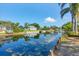 Scenic view of canal with lush greenery, waterfront access, and charming homes in the distance at 1104 76Th Nw St, Bradenton, FL 34209