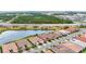 Beautiful aerial view of homes near a scenic lake in a Primary planned community at 11959 Tapestry Ln, Venice, FL 34293
